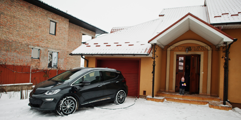 residential ev charger at a snowy house